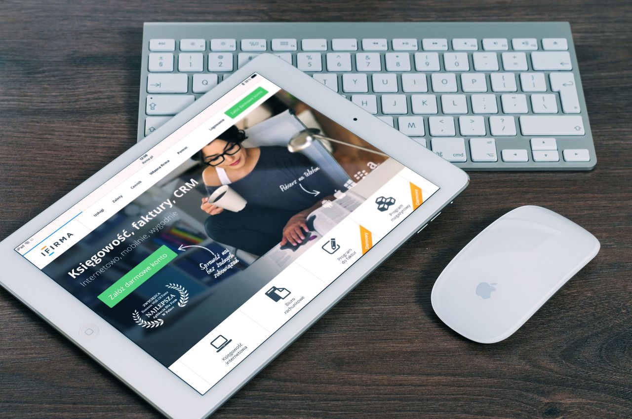 our-story A tablet with a financial website open, alongside a white keyboard and mouse. Ideal for tech-theme stock images.
