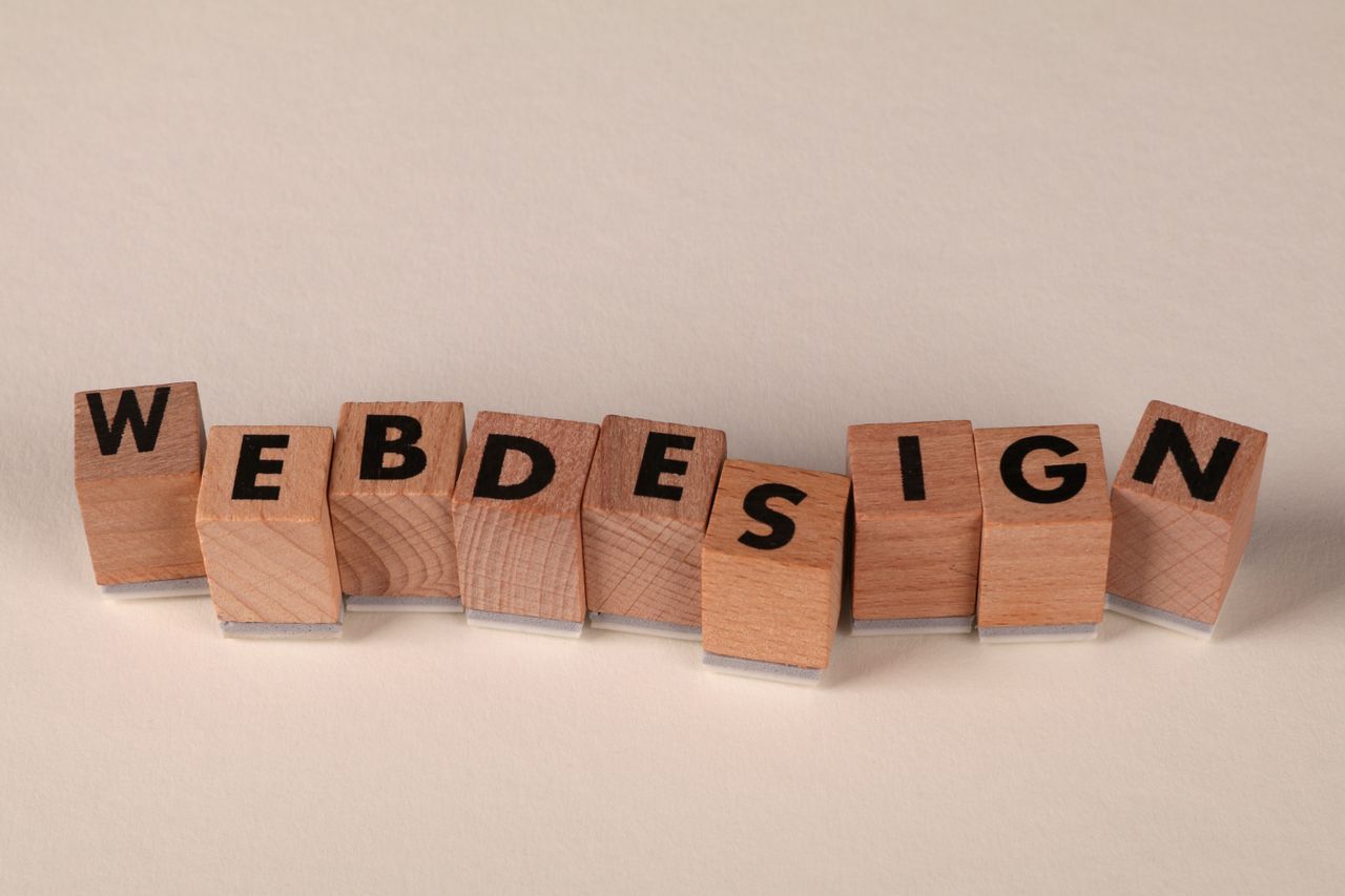 mobile-02 Wooden blocks spelling 'web design' creatively showcase digital design concept.
